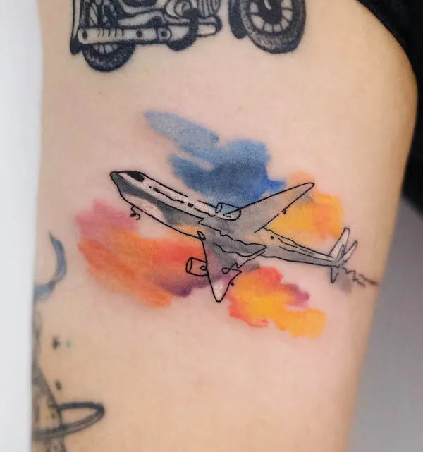 Plane tattoo with watercolor background by @ching_artist