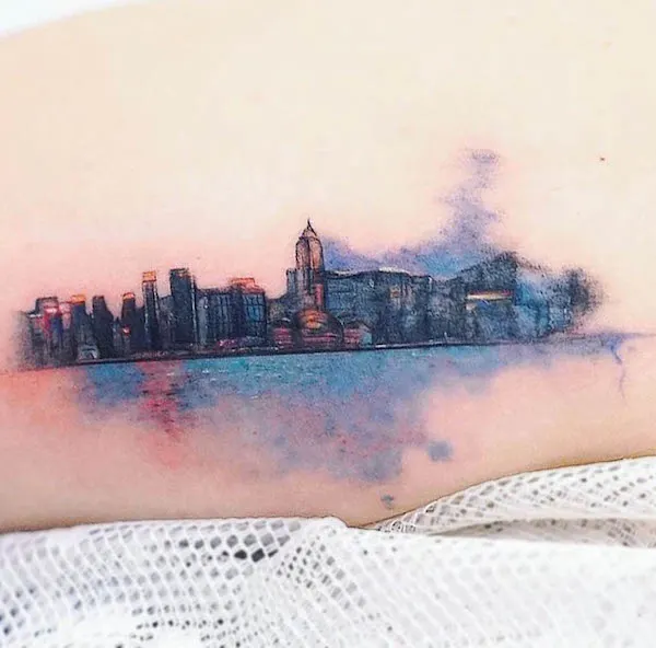 Watercolor cityscape tattoo by @minitattoo_studio