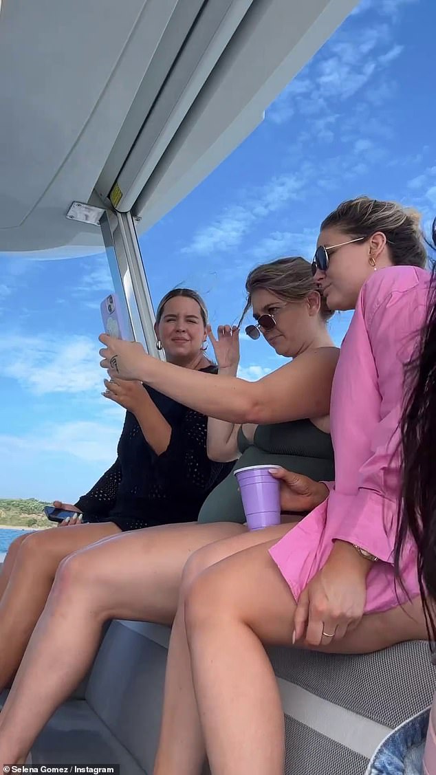 On an adventure: The Grammy nominee went on to share a sweet snap with two female pals, in which she rocked a paired of light-wash overalls with giant rips on both knees