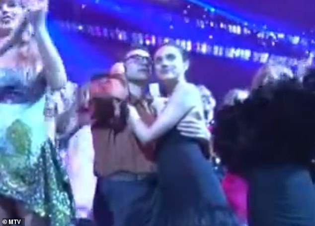 While everyone else in the audience around them - including Taylor Swift, Tyla and Suki Waterhouse - dances to Perry's melody, Antonoff is seen putting something in his ears while the pair stand still