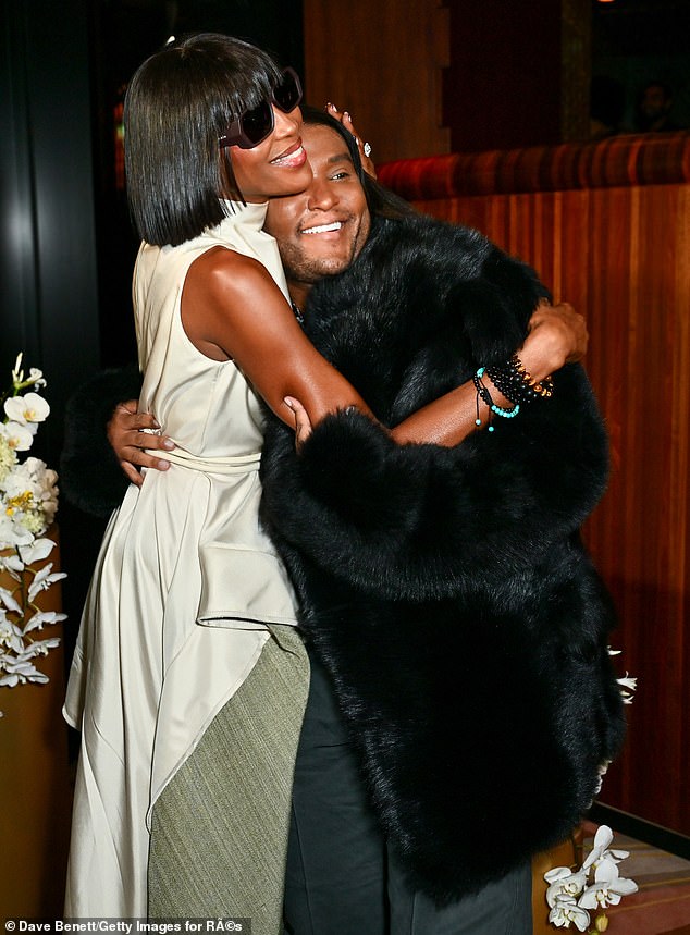 Naomi, 54, seemed in good spirits during the star studded launch event as she hugged Law, 46