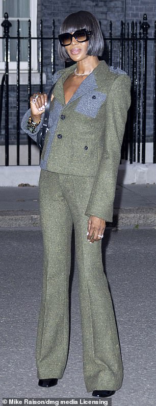 She displayed her stunning figure in the fitted jacket which she teamed with matching flared trousers