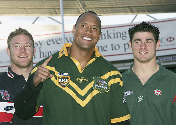 Actor Dwayne "The Rock" Johnson receives the Australian Rugby League official "Kangaroo" Jersey and ball from a selection of national players at the...