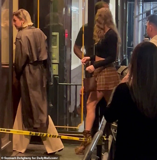 Taylor additionally wore a long-sleeved, black cropped top and slipped into a pair of brown-patterned, heeled ankle boots that were secured with black laces