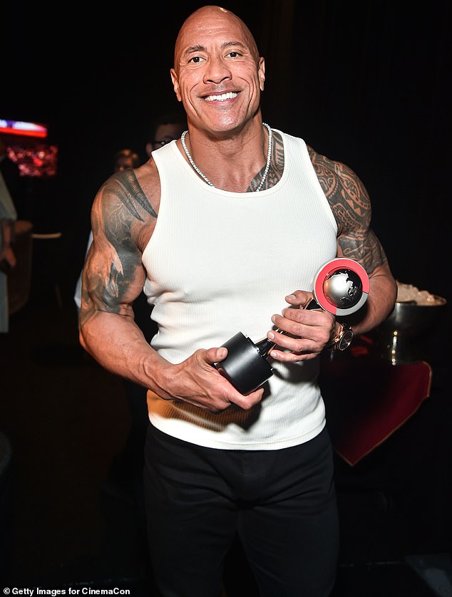 After he left the stage, Dwayne posed proudly with his prize, flashing his unmistakable megawatt smile for the camera